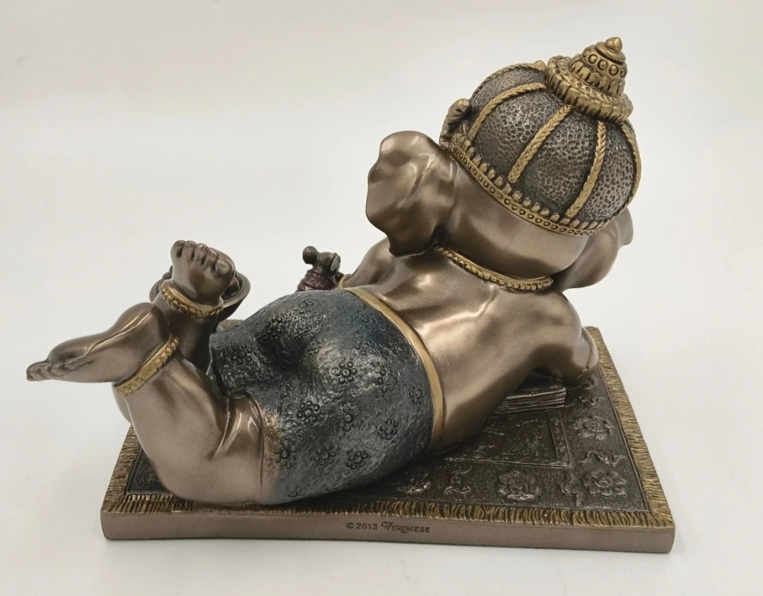 Back view of medium polyresin Baby Ganesh sculpture lying on stomach