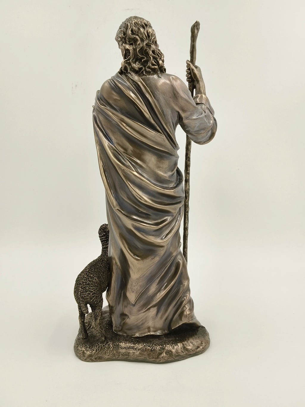 Back view of polyresin Jesus Christ sculpture with a sheep and staff
