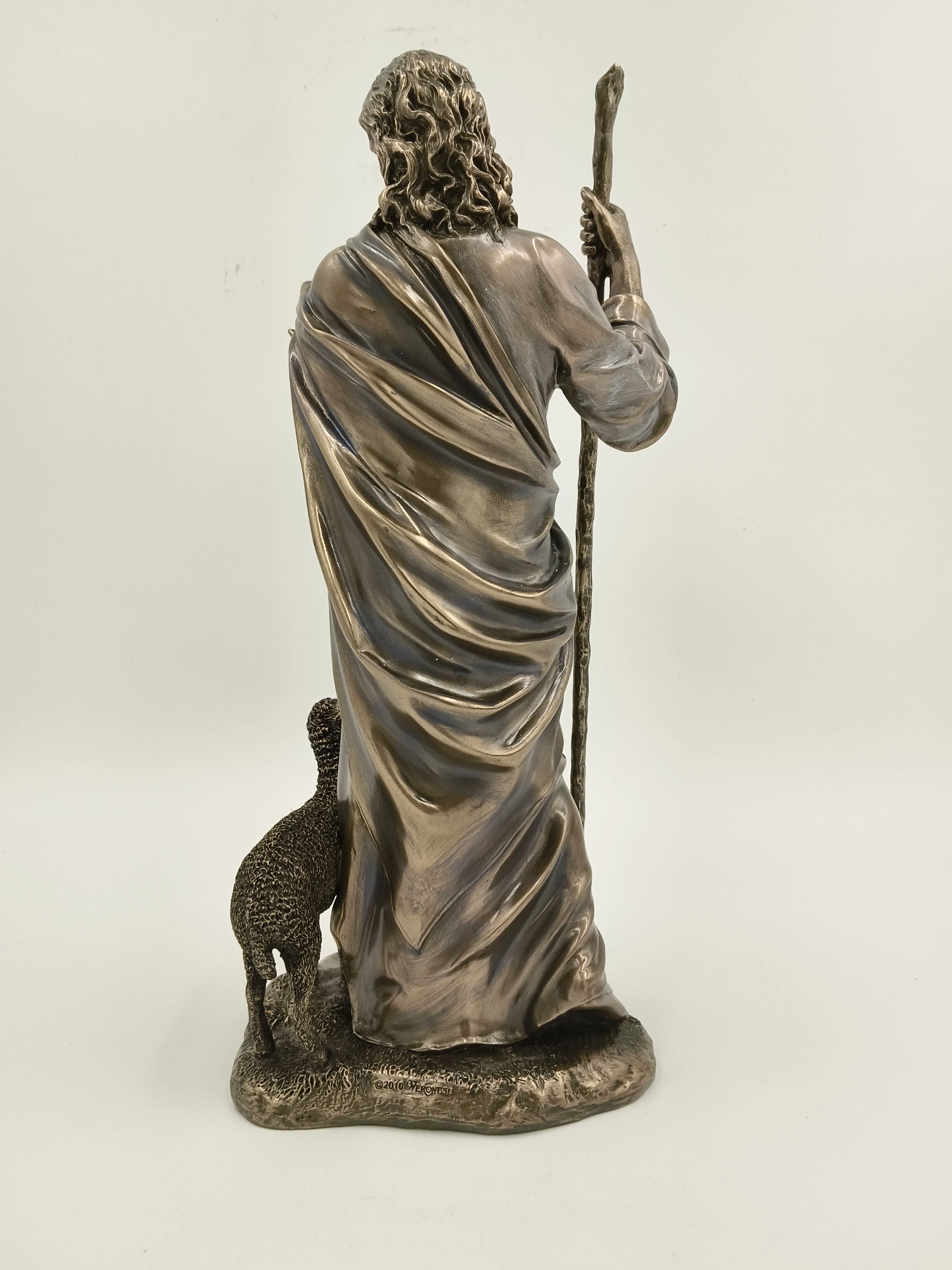 Back view of polyresin Jesus Christ sculpture with a sheep and staff