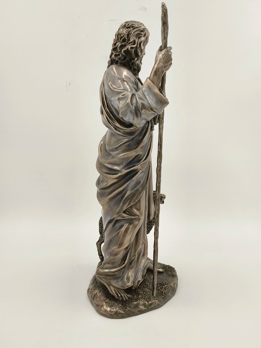 Side view of polyresin sculpture of Jesus Christ holding a staff with sheep