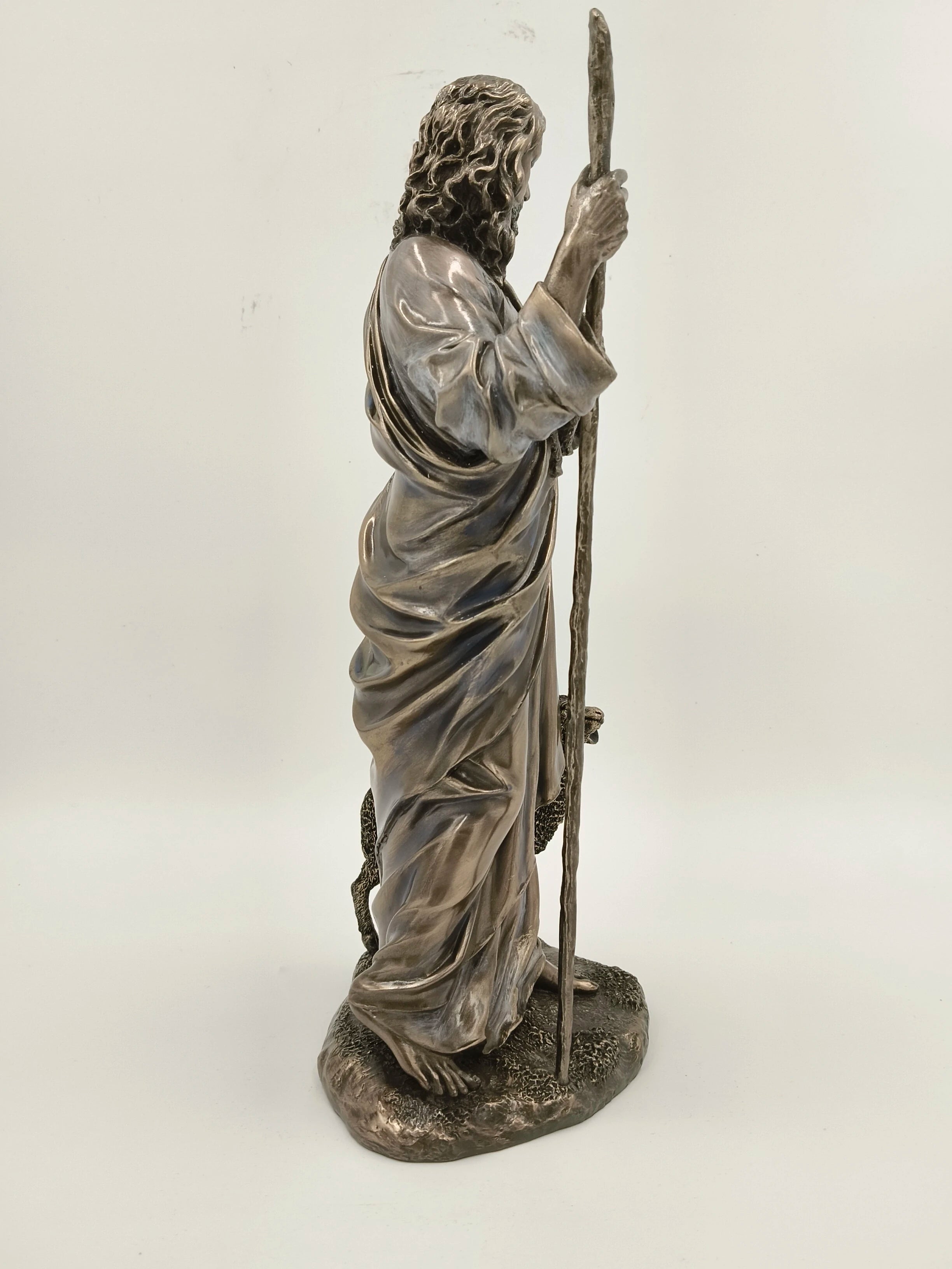 Side view of polyresin sculpture of Jesus Christ holding a staff with sheep
