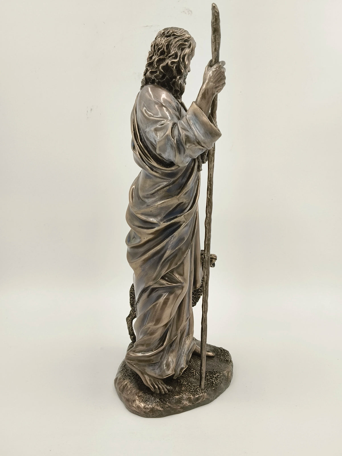 Side view of polyresin sculpture of Jesus Christ holding a staff with sheep