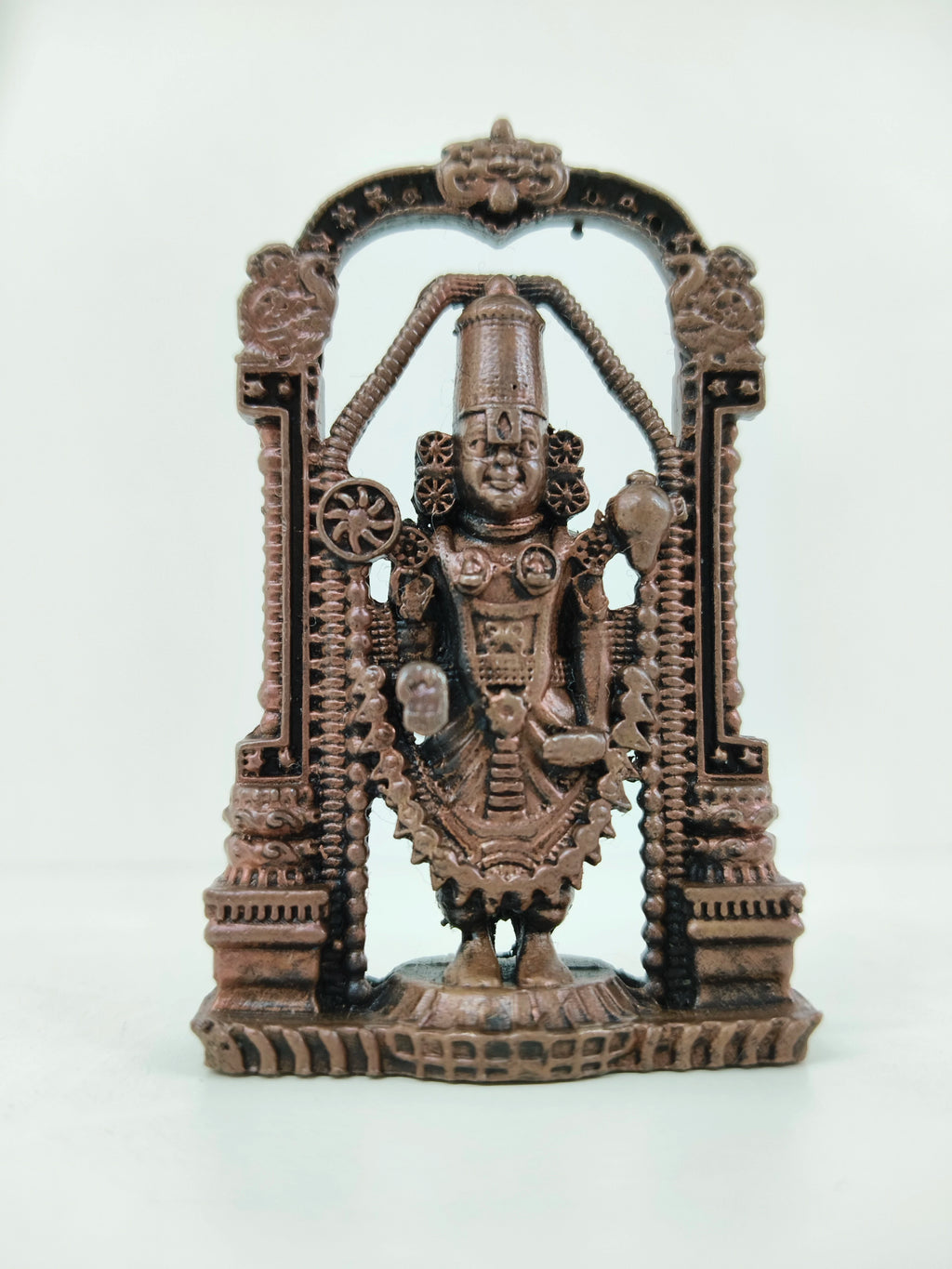 Mini copper statue of Balaji deity within decorative arch