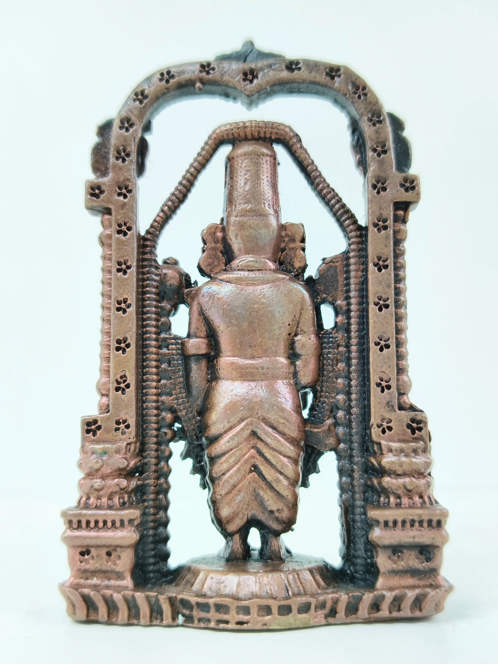 Back view of mini copper arch Balaji statue with detailed floral arch design