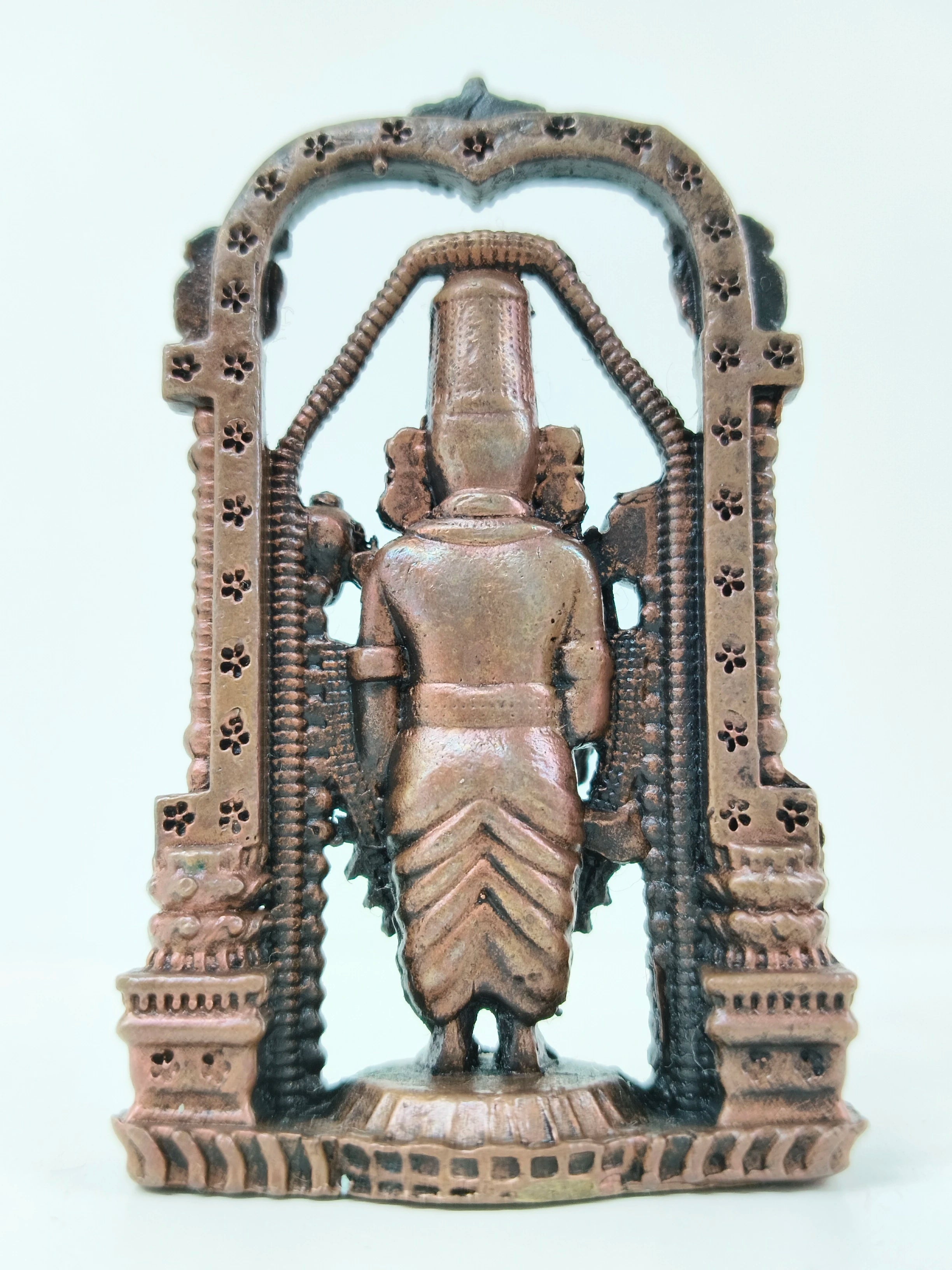 Back view of mini copper arch Balaji statue with detailed floral arch design