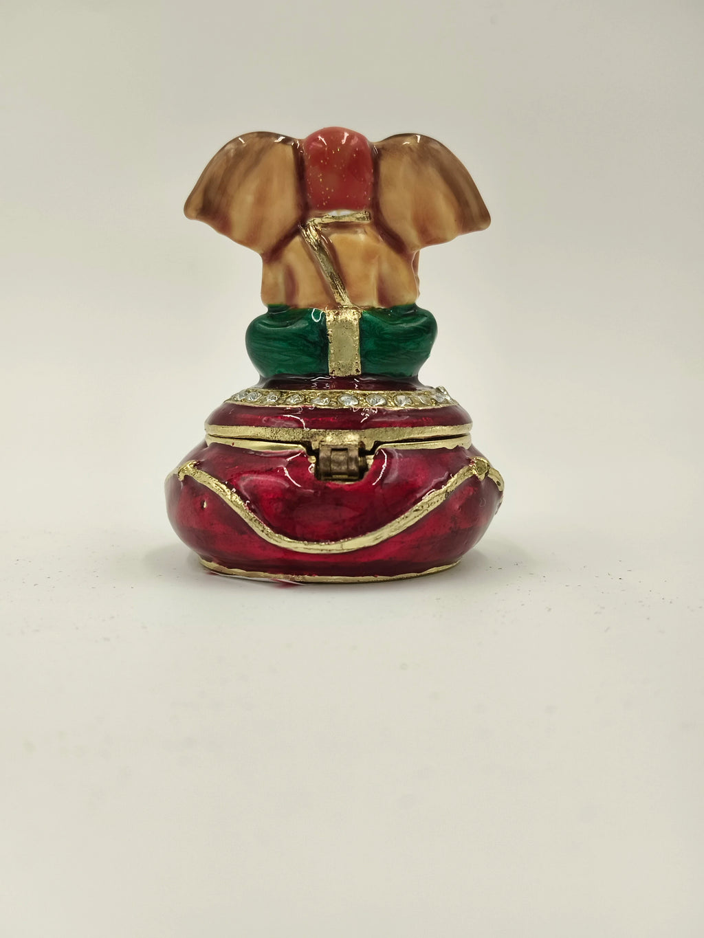Compact brass enamel box shaped like seated Ganesh with red and green accents