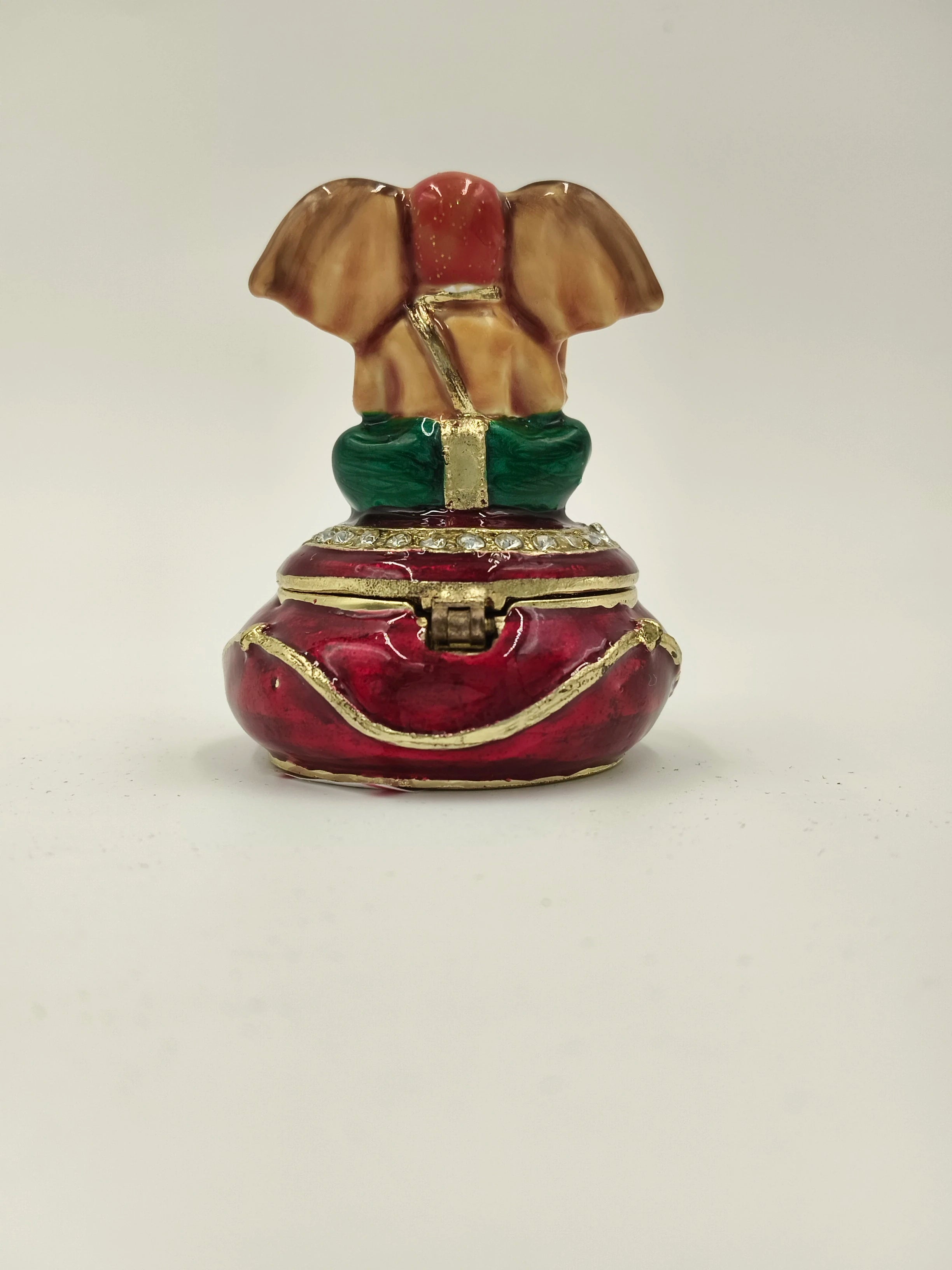 Compact brass enamel box shaped like seated Ganesh with red and green accents