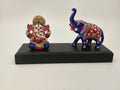 Small brass Ganesh statue with a painted blue elephant on black base