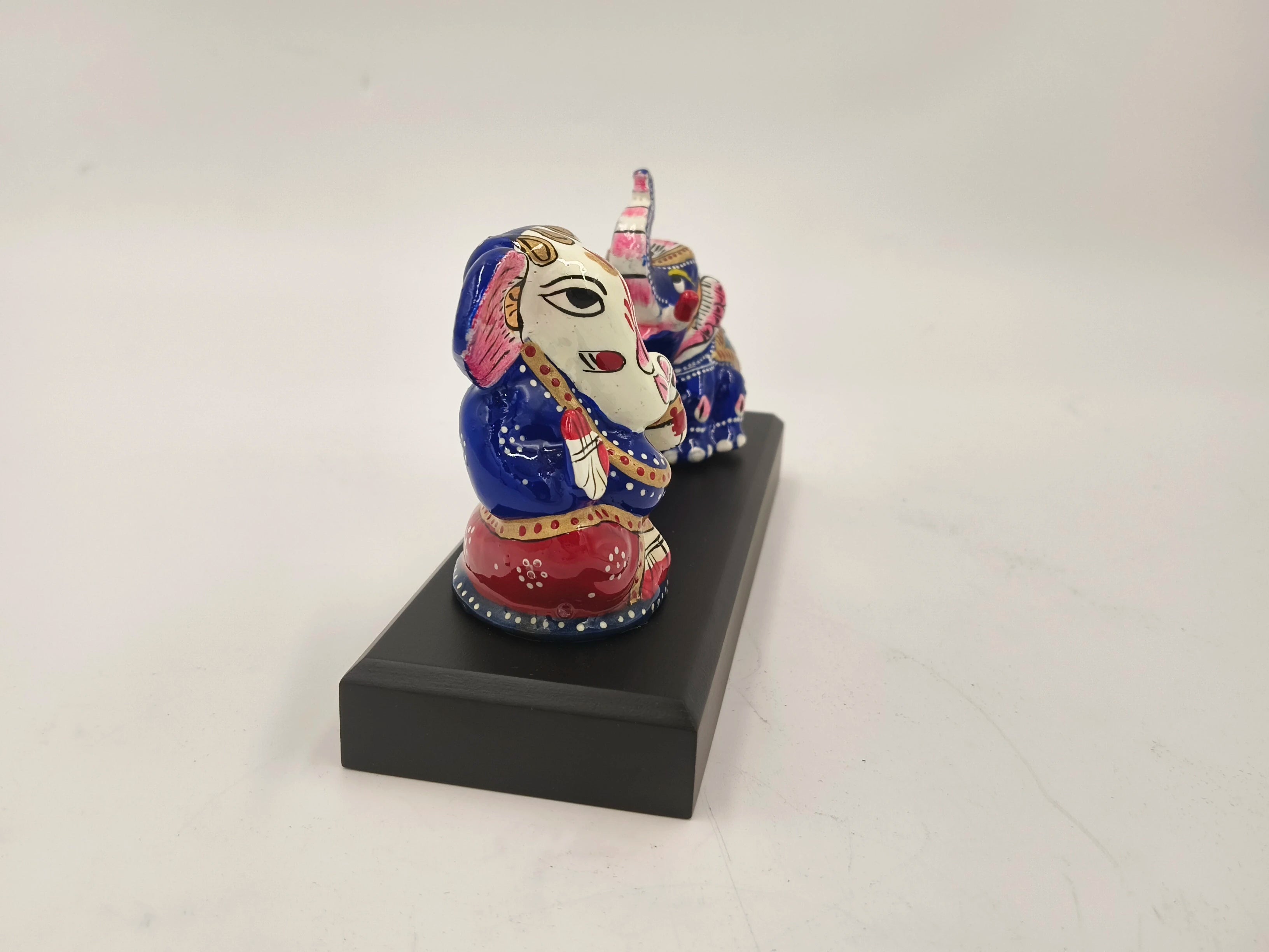 Colorful hand-painted Ganesh and elephant brass figurines on black base