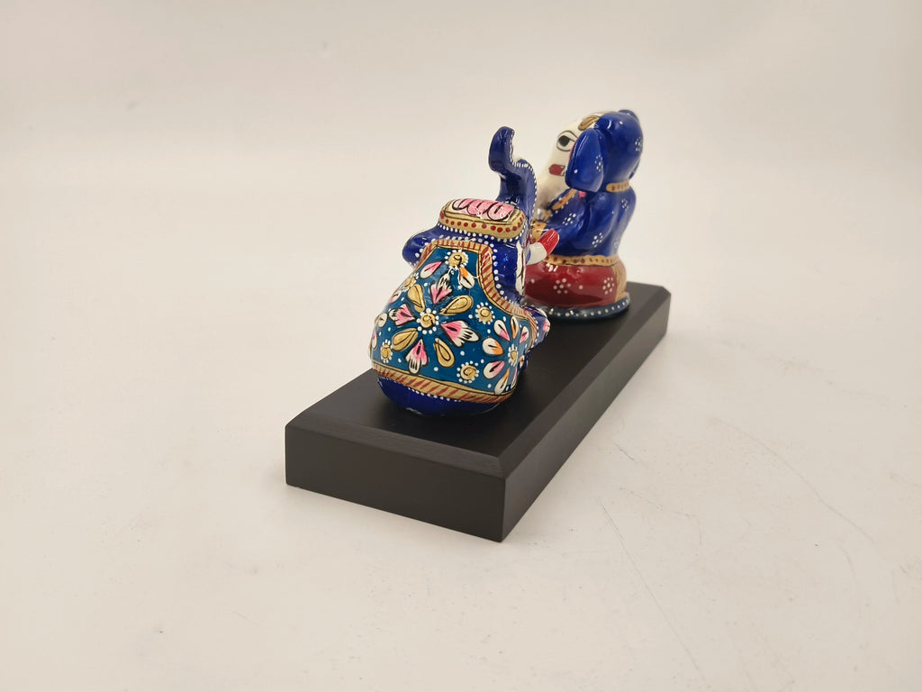Hand-painted blue and red brass Ganesh sculpture with elephant on black base