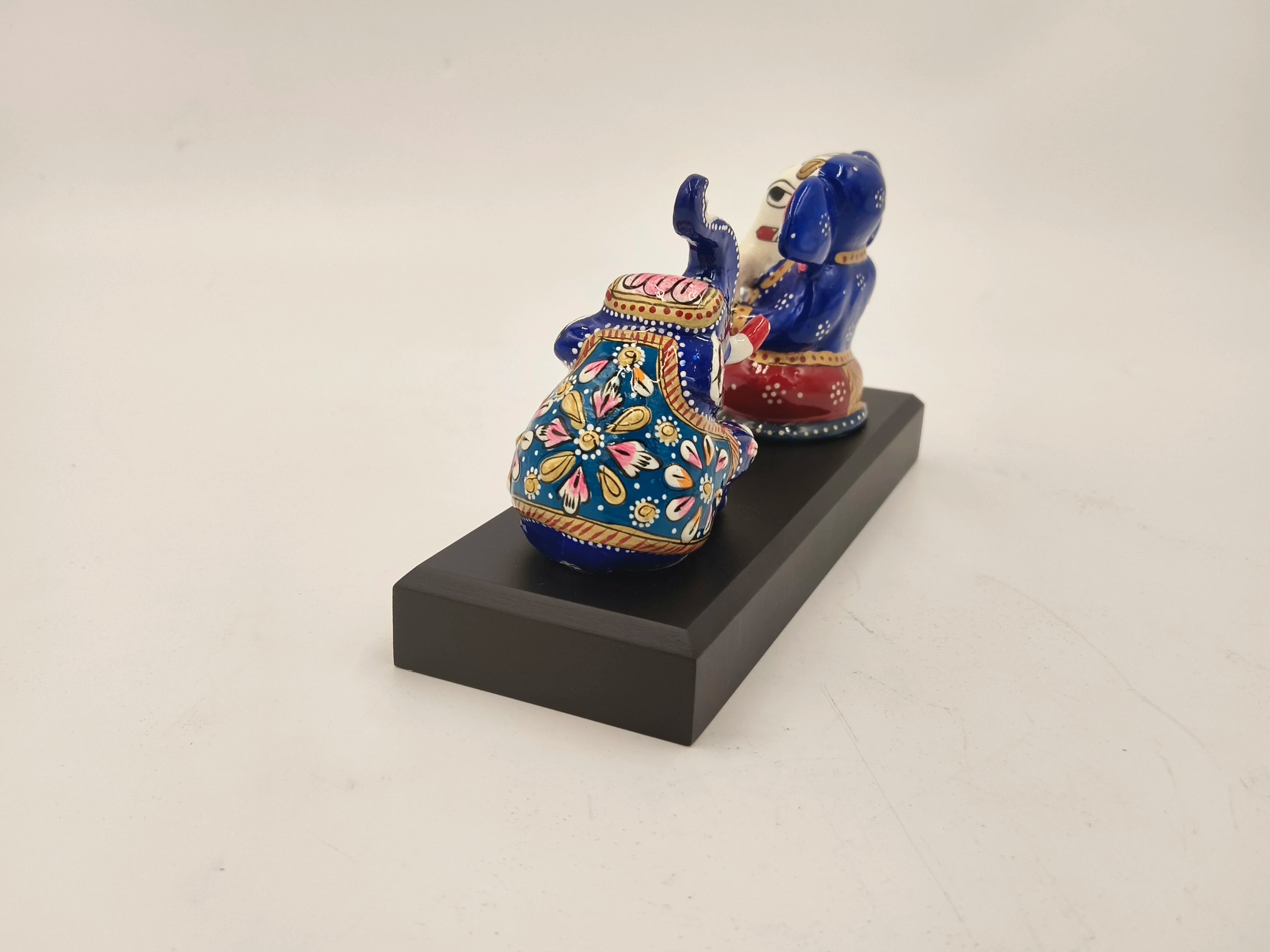 Hand-painted blue and red brass Ganesh sculpture with elephant on black base