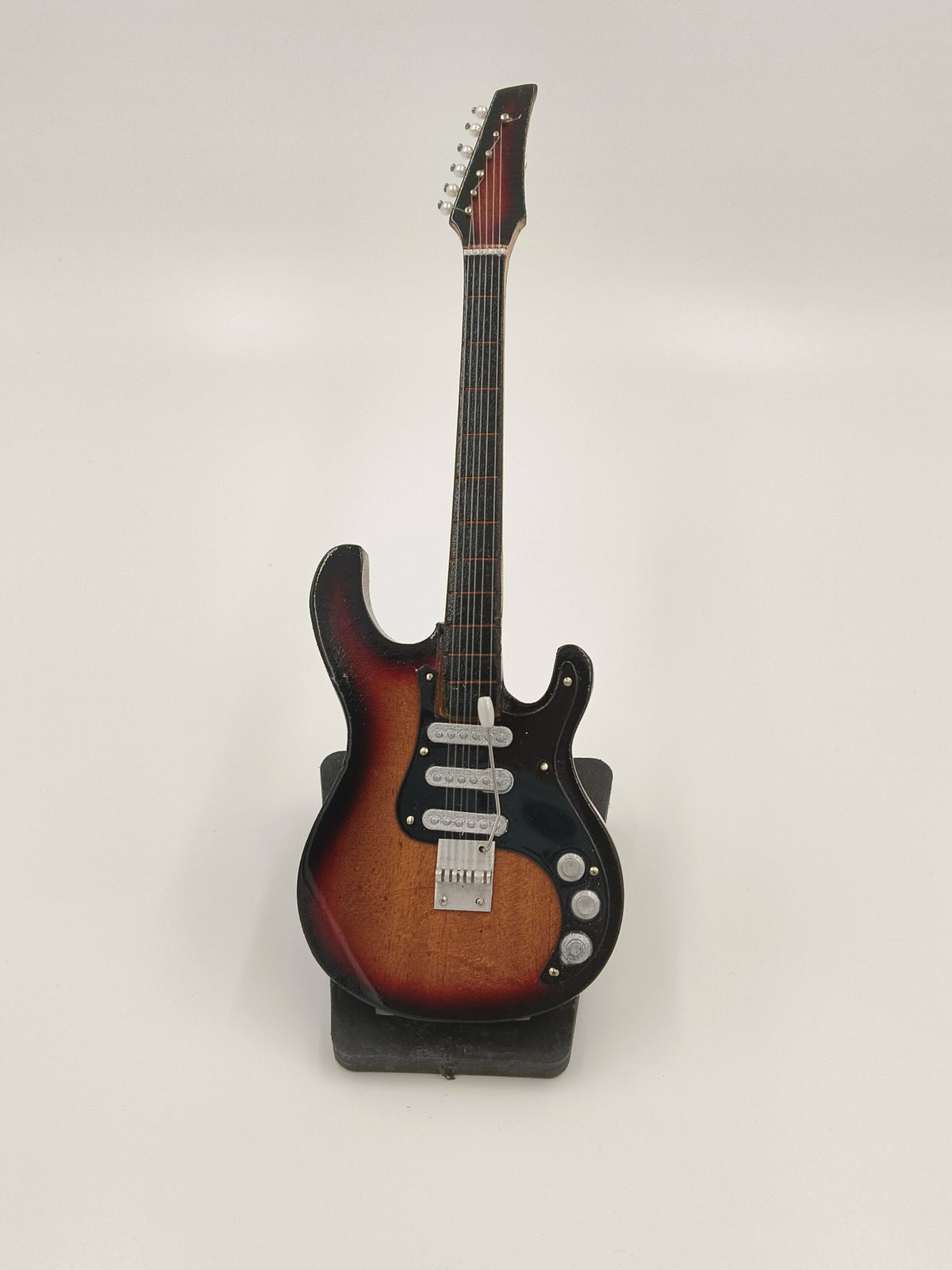 Large wooden guitar sculpture with sunburst finish on stand