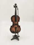 Large wooden violin sculpture with bow on black stand
