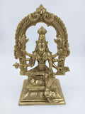 Large brass sculpture of Goddess Varahi seated with multiple arms under an ornate arch