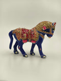 small blue enamel horse figurine with red and gold decorative patterns side view
