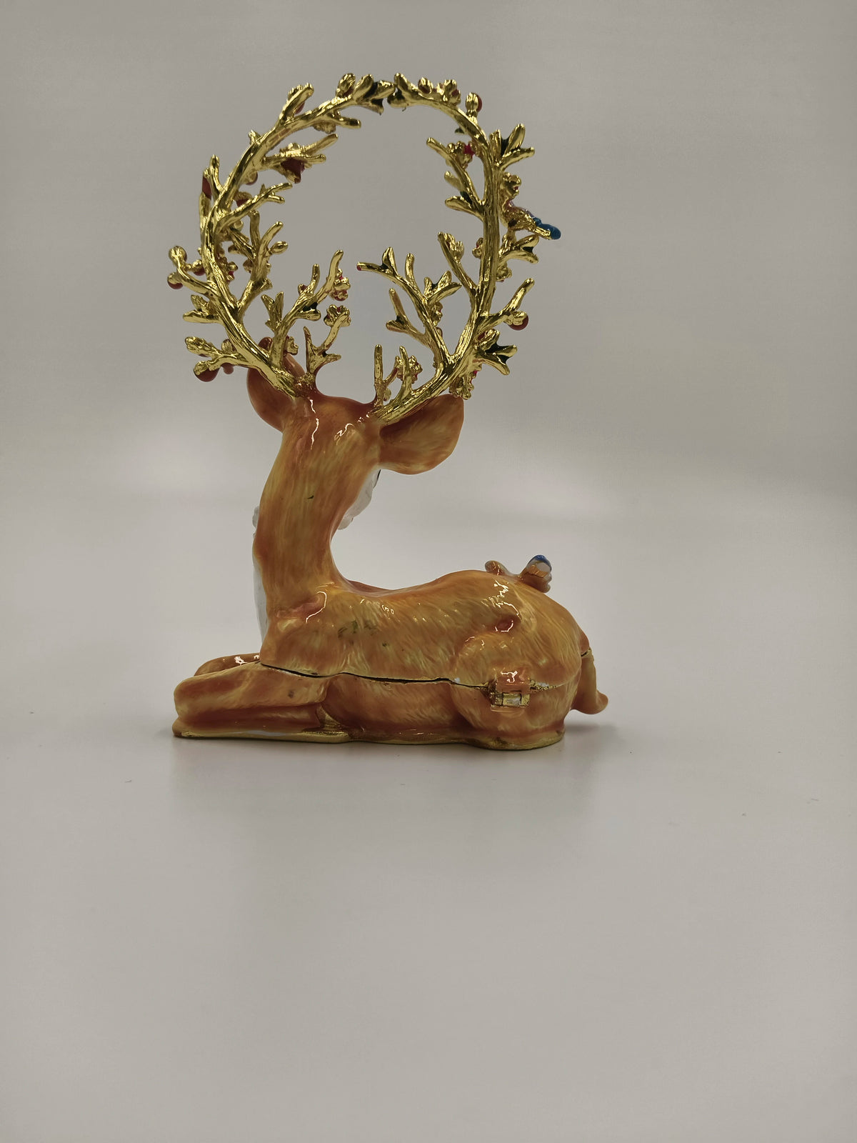 Brass enamel deer figurine with ornate golden antlers, side view