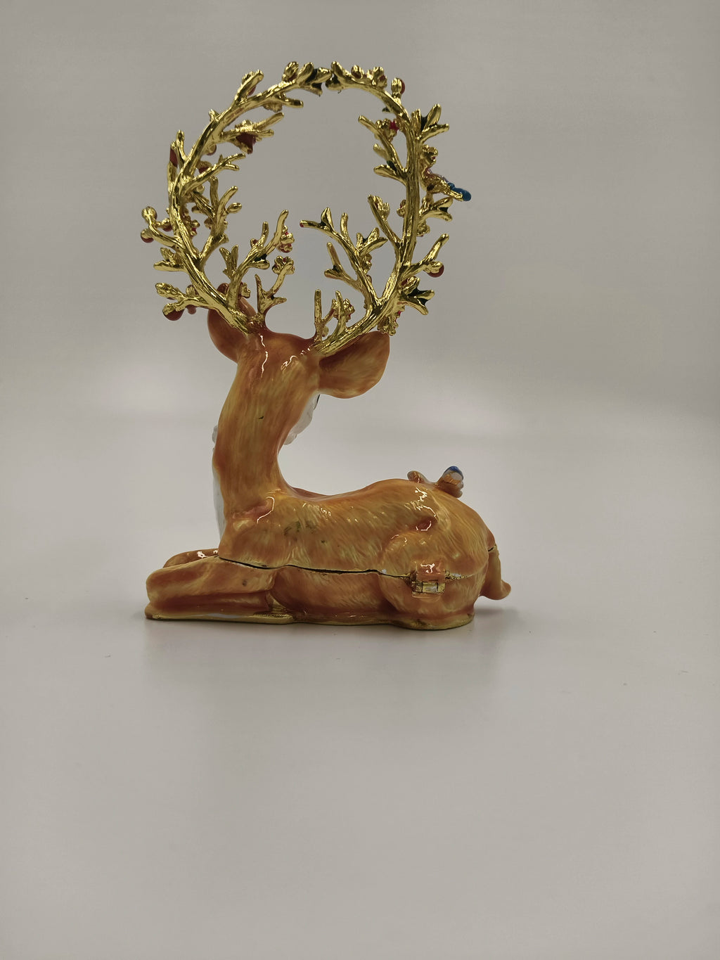 Brass enamel deer figurine with ornate golden antlers, side view