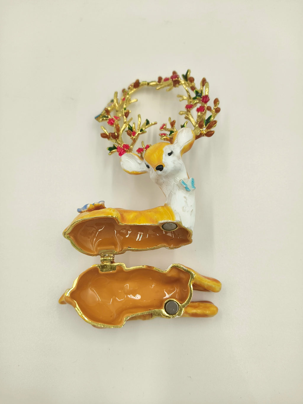 Open brass enamel deer figurine with floral antlers and butterfly detail