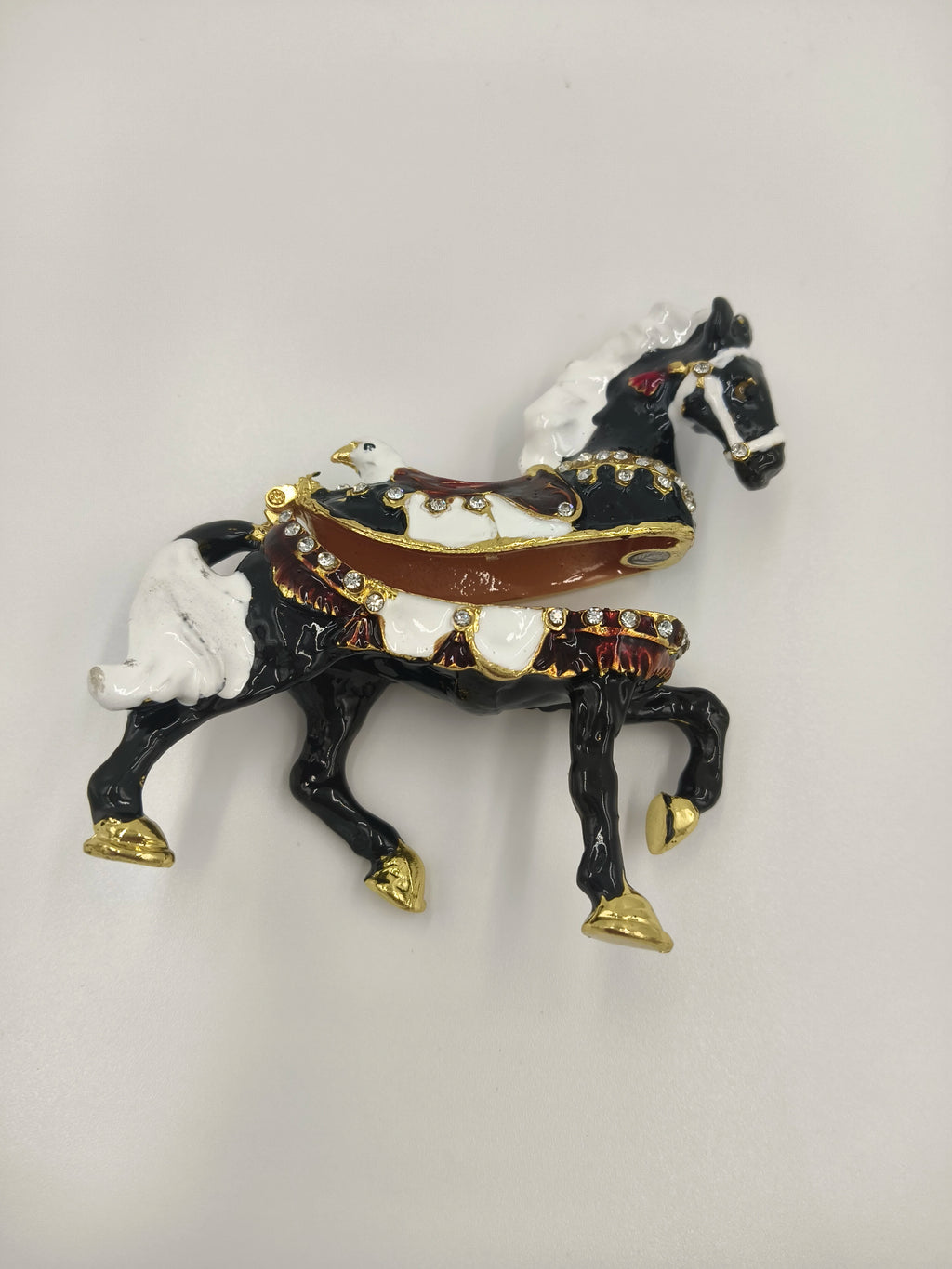 Small brass black horse figurine with white mane and decorative saddle