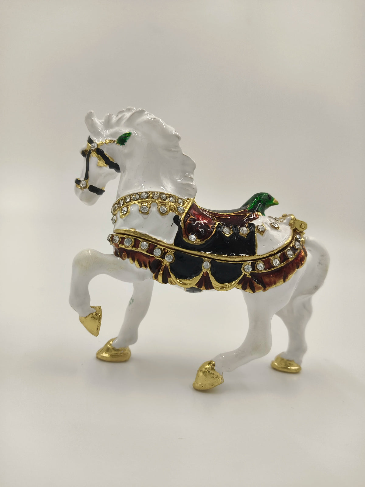 Small brass and enamel white horse figurine with decorative saddle and gold accents
