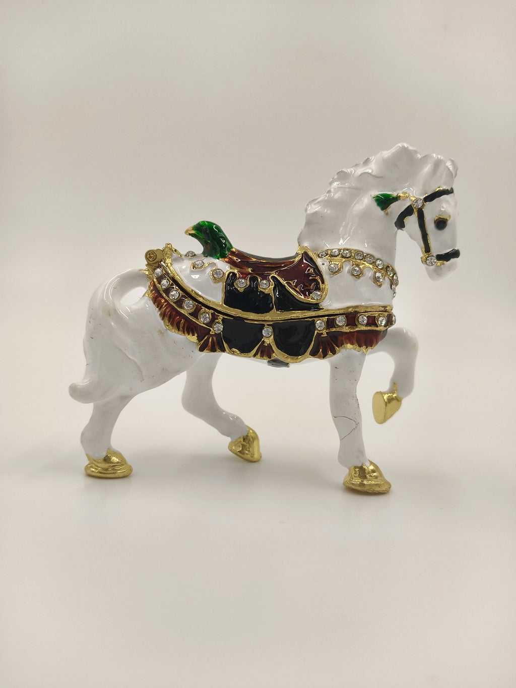 Small brass white horse figurine with enamel, decorated saddle, and gemstone accents