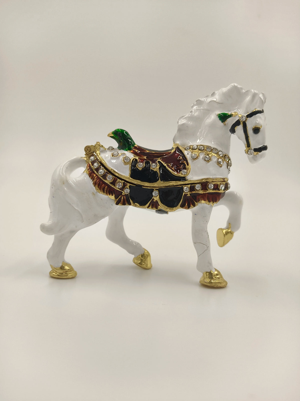 Small brass white horse figurine with enamel, decorated saddle, and gemstone accents
