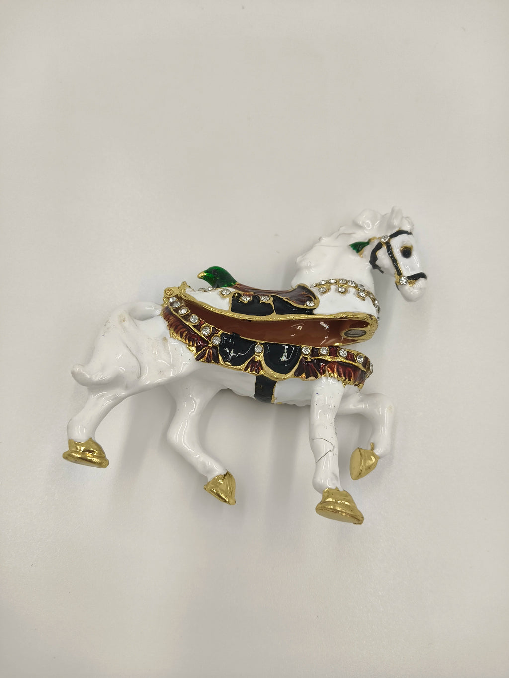 Small brass and enamel white horse figurine with decorative saddle and gold accents