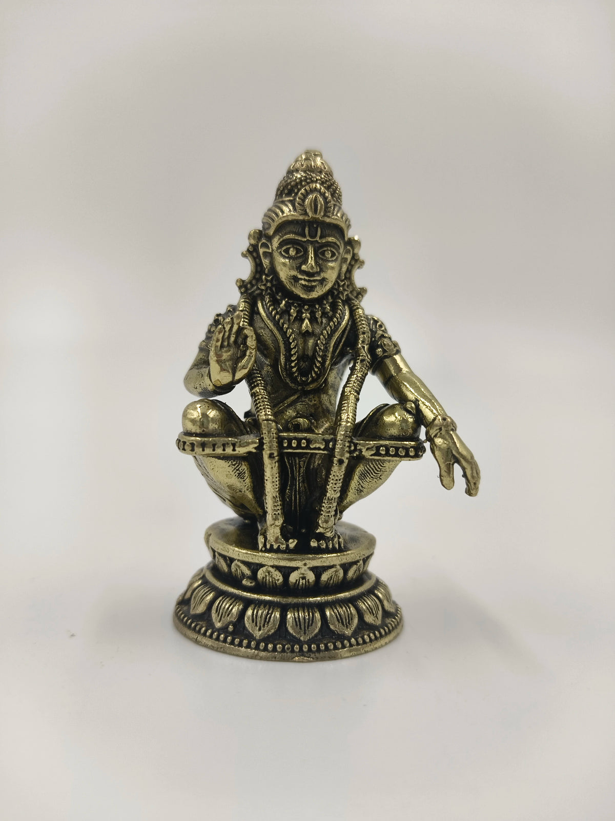 Mini brass sculpture of deity Ayyappa seated on lotus base with detailed jewelry