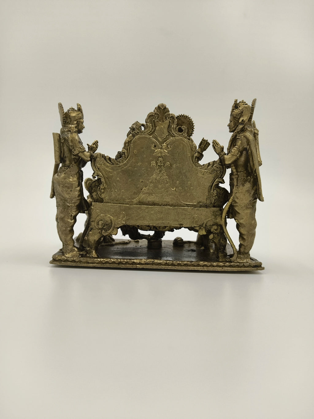 Back view of small brass Ram Parivar sculpture with two standing figures
