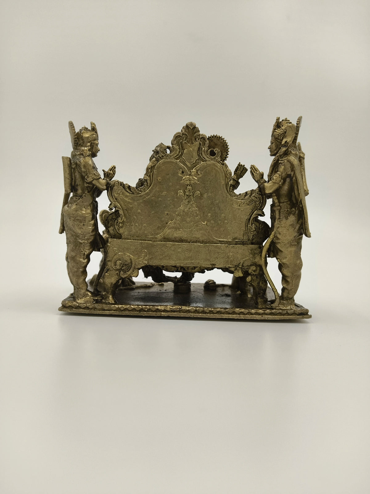 Back view of small brass Ram Parivar sculpture with two standing figures