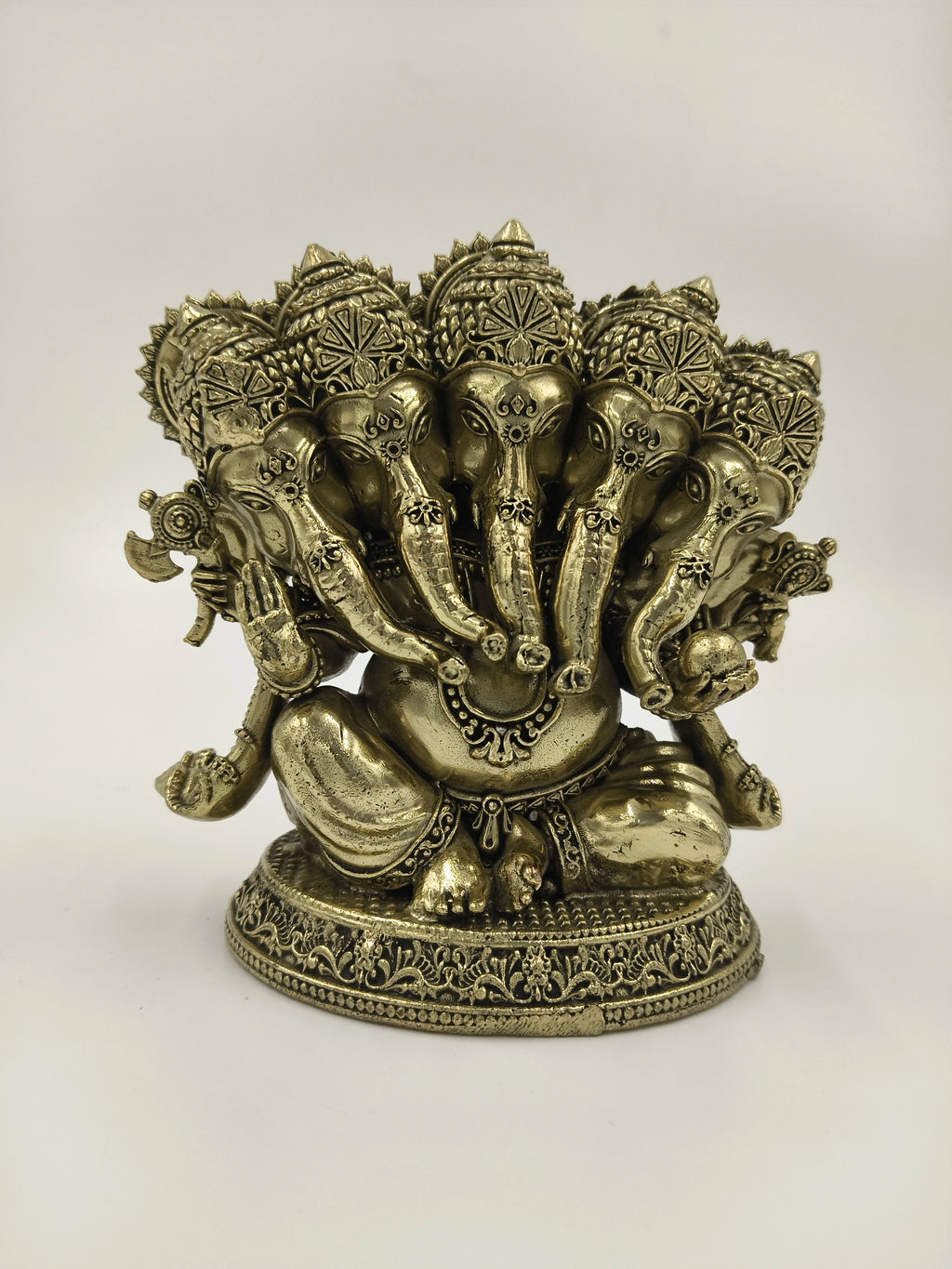 Brass Panchamukhi Ganesha sculpture with five elephant heads seated on decorative base