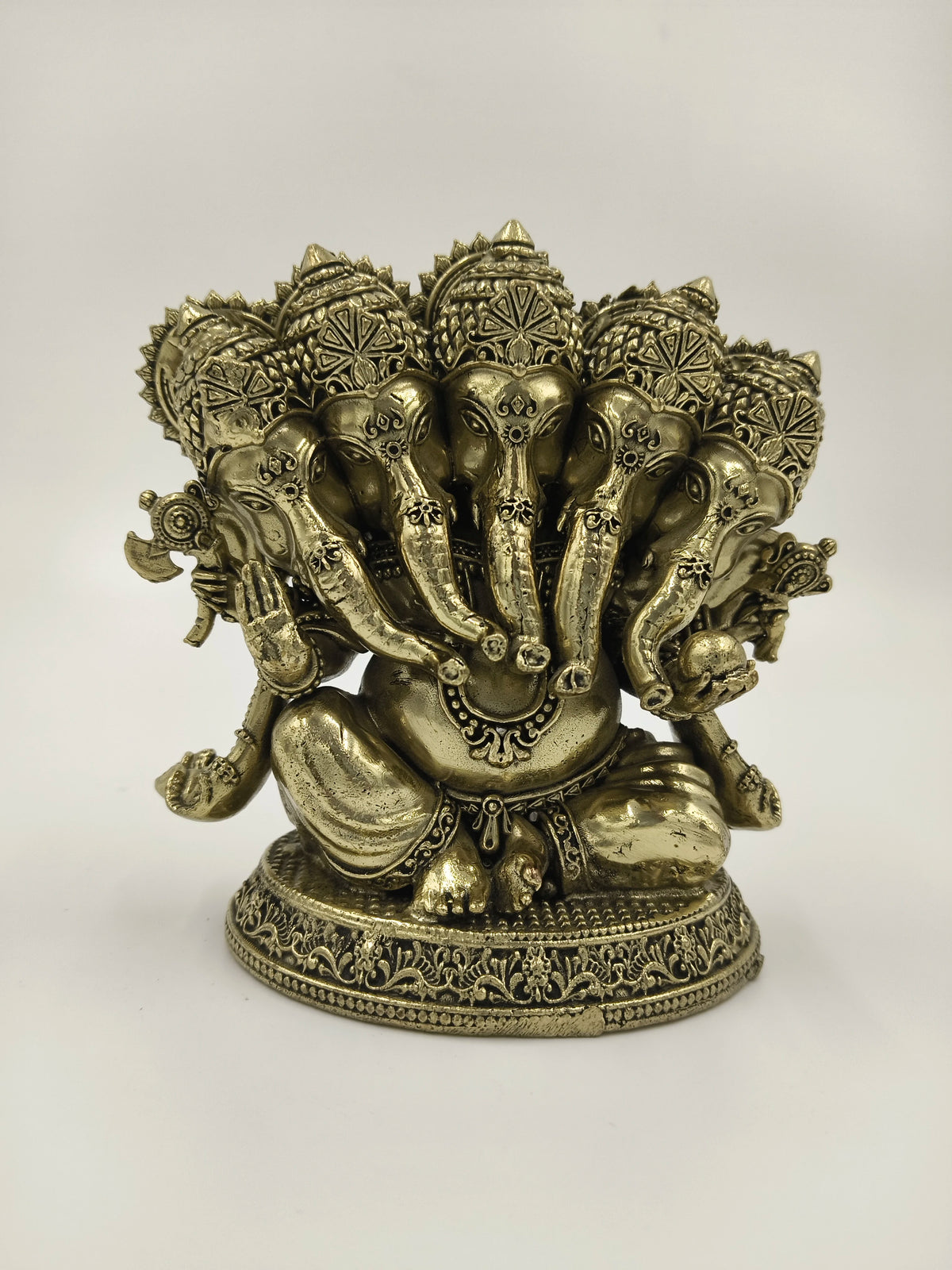 Brass Panchamukhi Ganesha sculpture with five elephant heads seated on decorative base