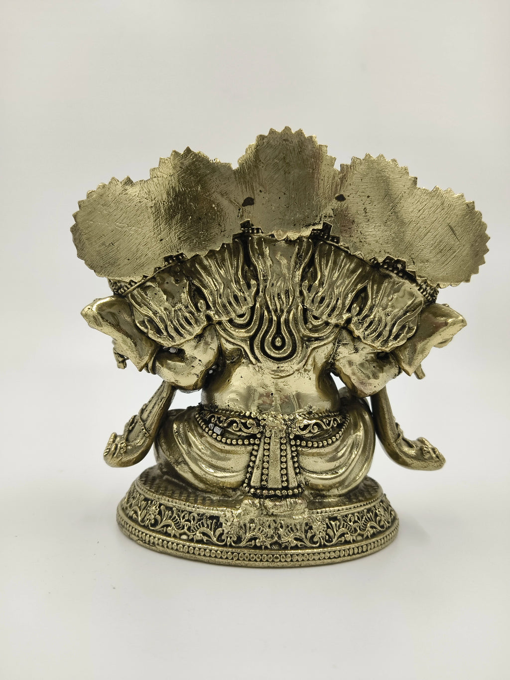 Back view of a small brass Panchamukhi Ganesha sculpture with intricate detailing