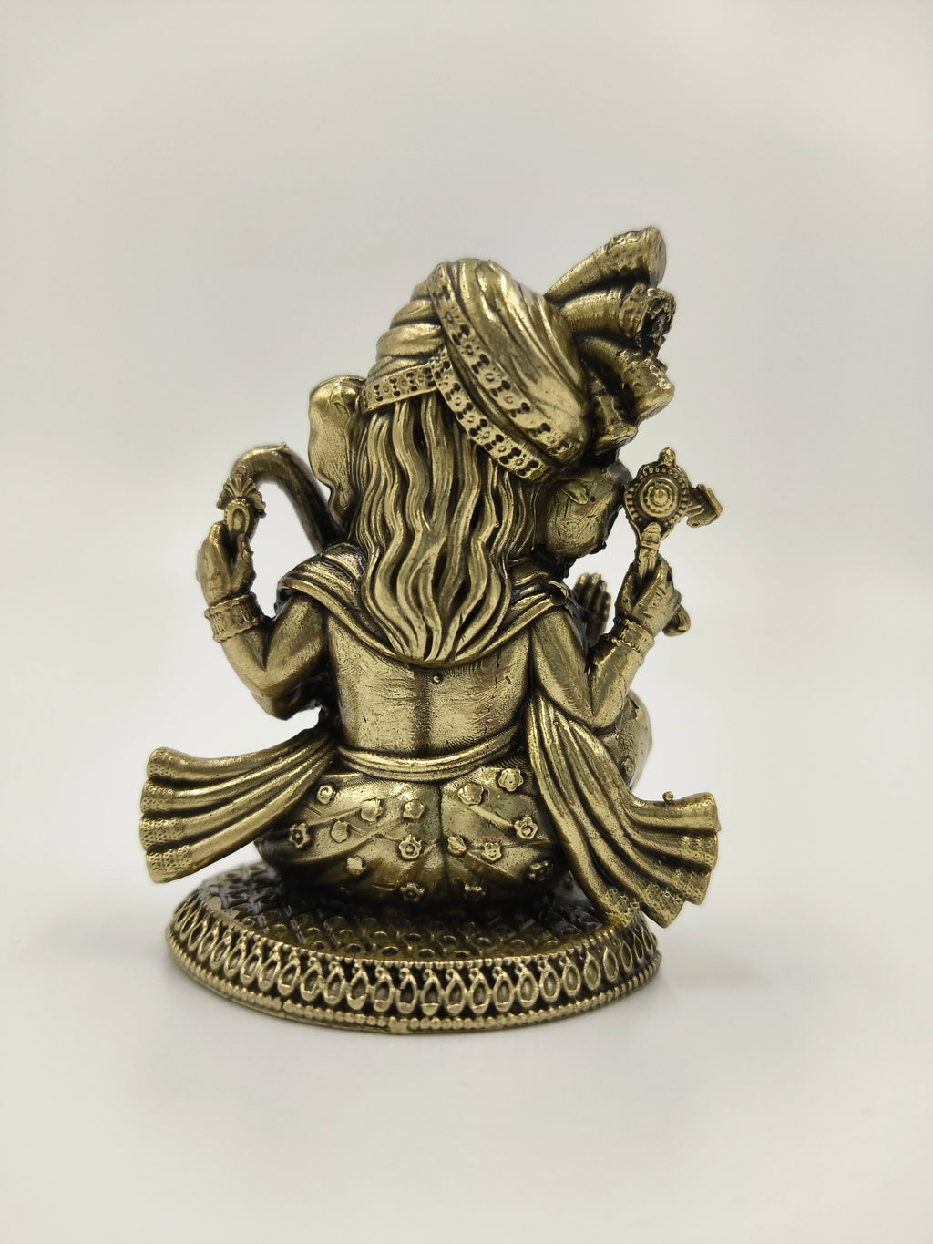 Back view of mini brass Radhakrishna statue with detailed attire and base