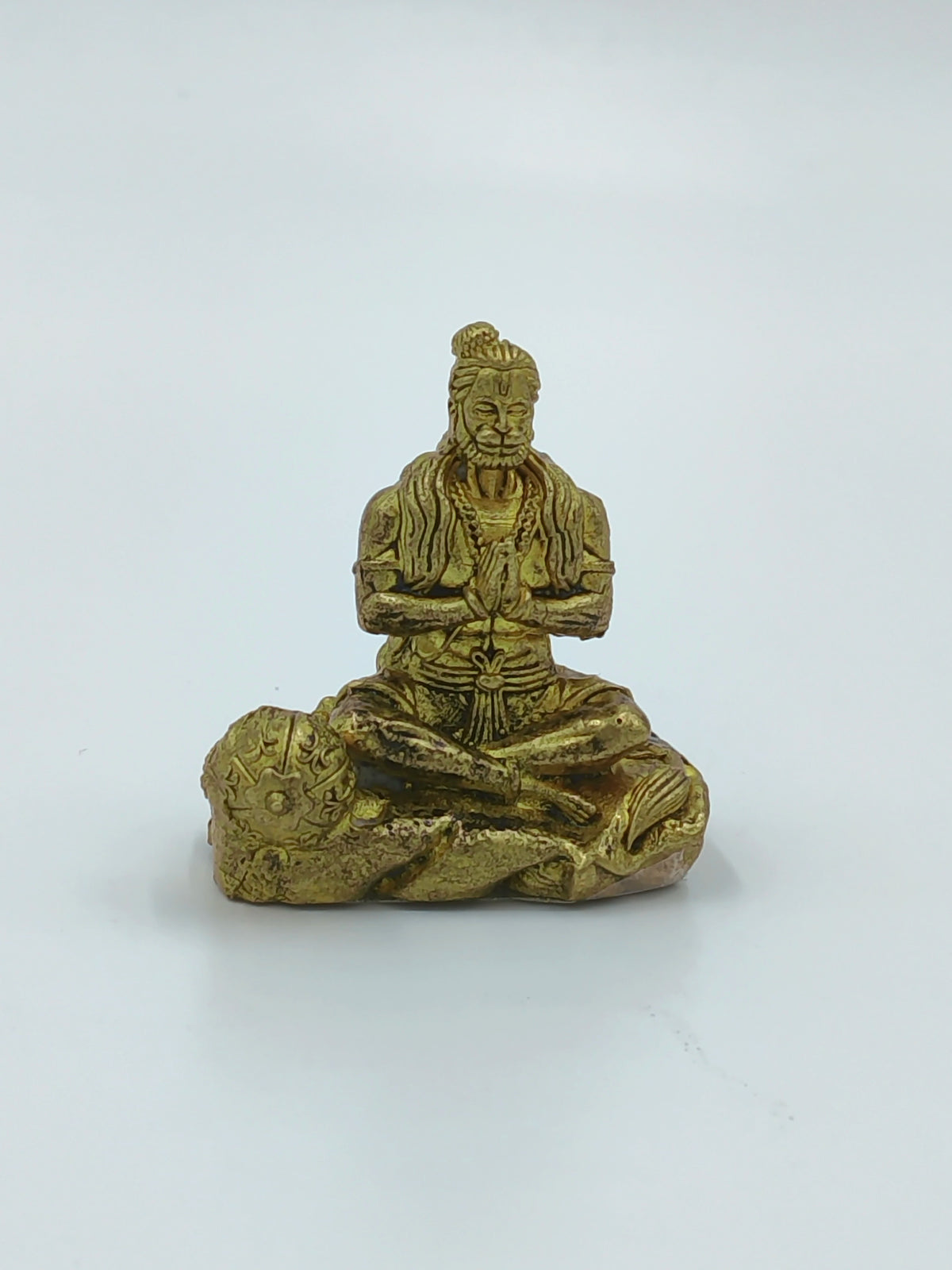 Mini brass Hanuman sculpture sitting cross-legged with hands in prayer