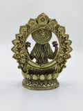 Back view of small brass Lakshmi statue with decorative arch and lotus base