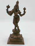 Large bronze Krishna sculpture standing on a decorated square base