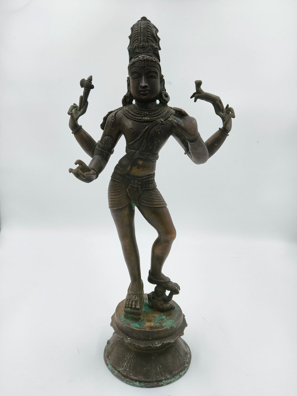 Large bronze statue of standing Shiva with four arms on a decorative base