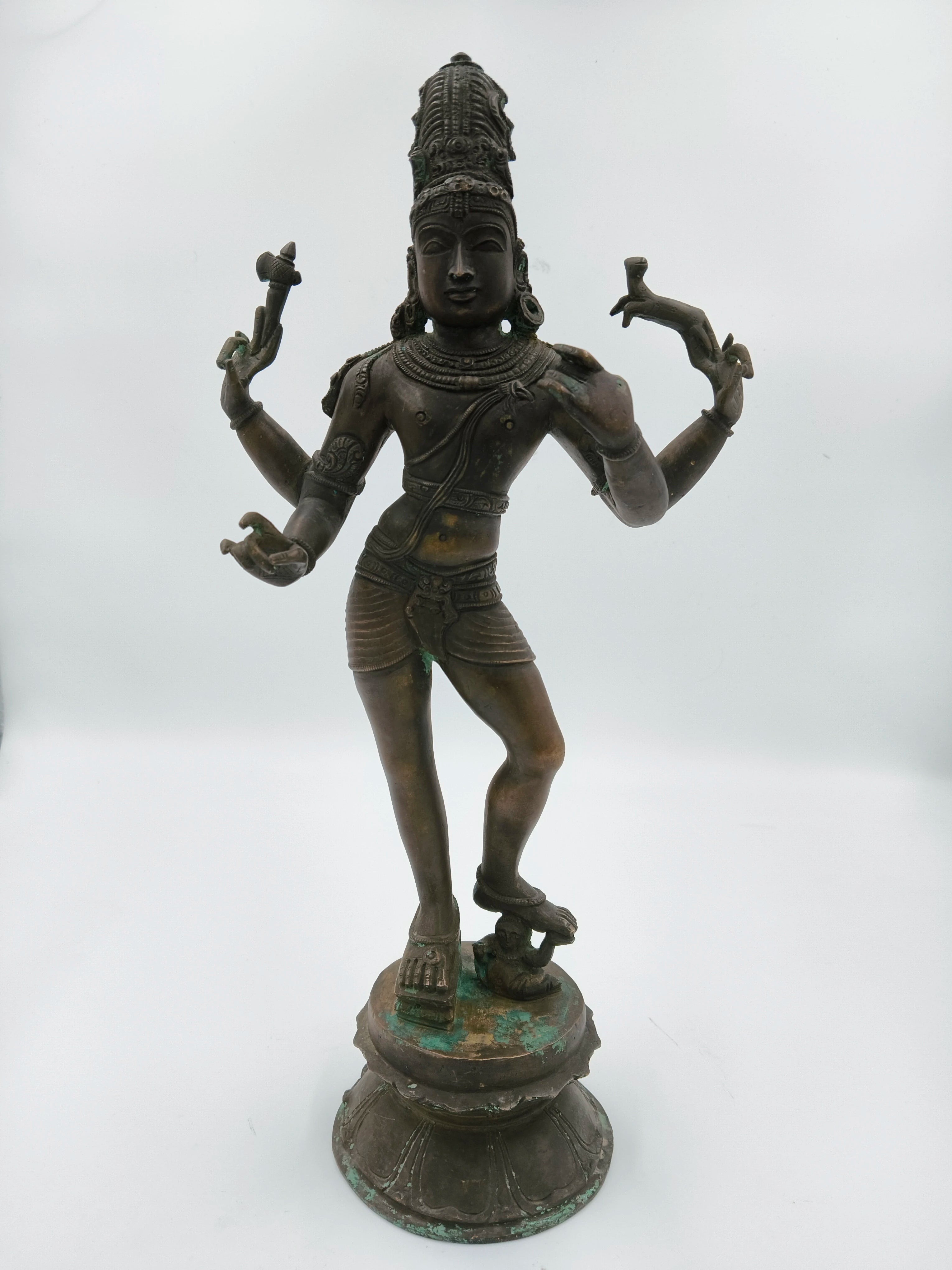 Large bronze statue of standing Shiva with four arms on a decorative base