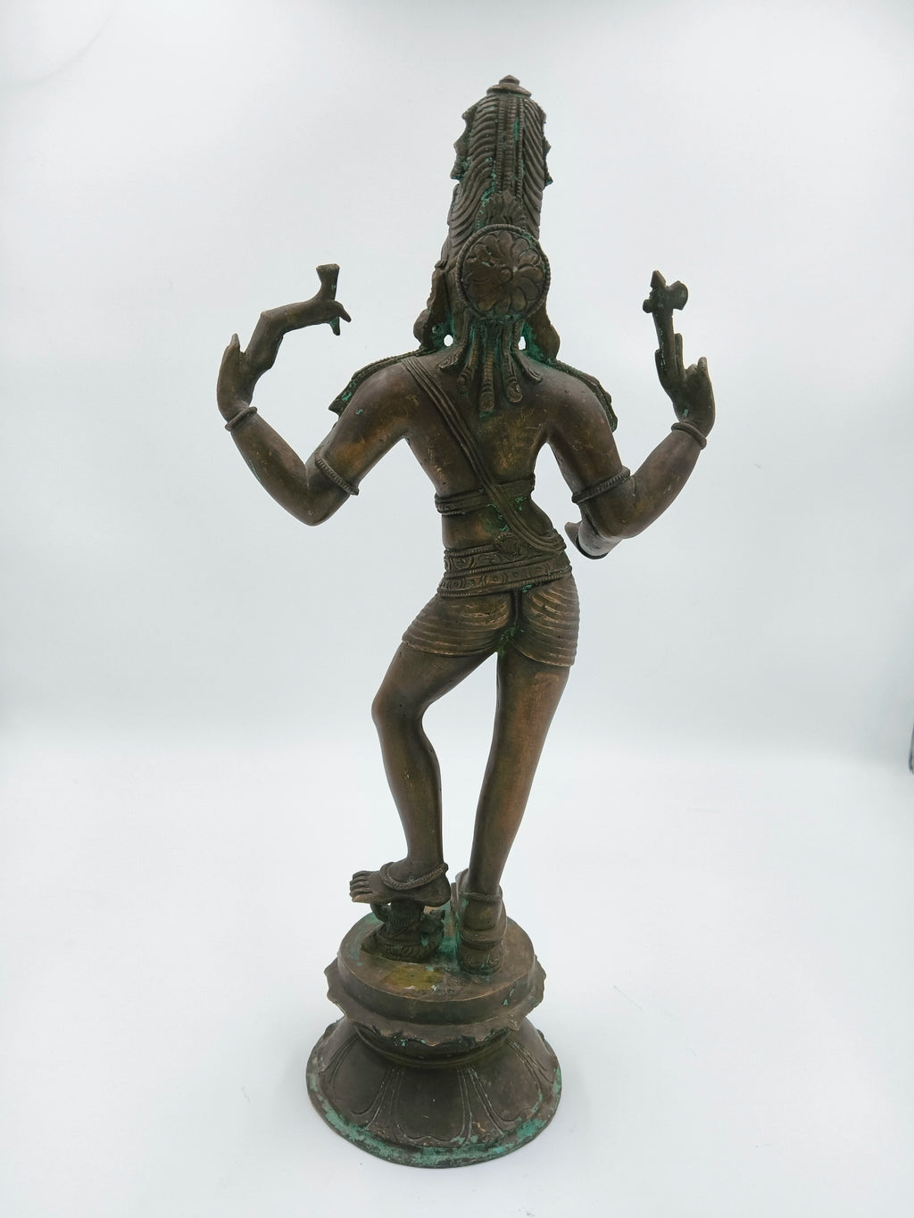 Back view of a large bronze standing Shiva sculpture on a decorative base