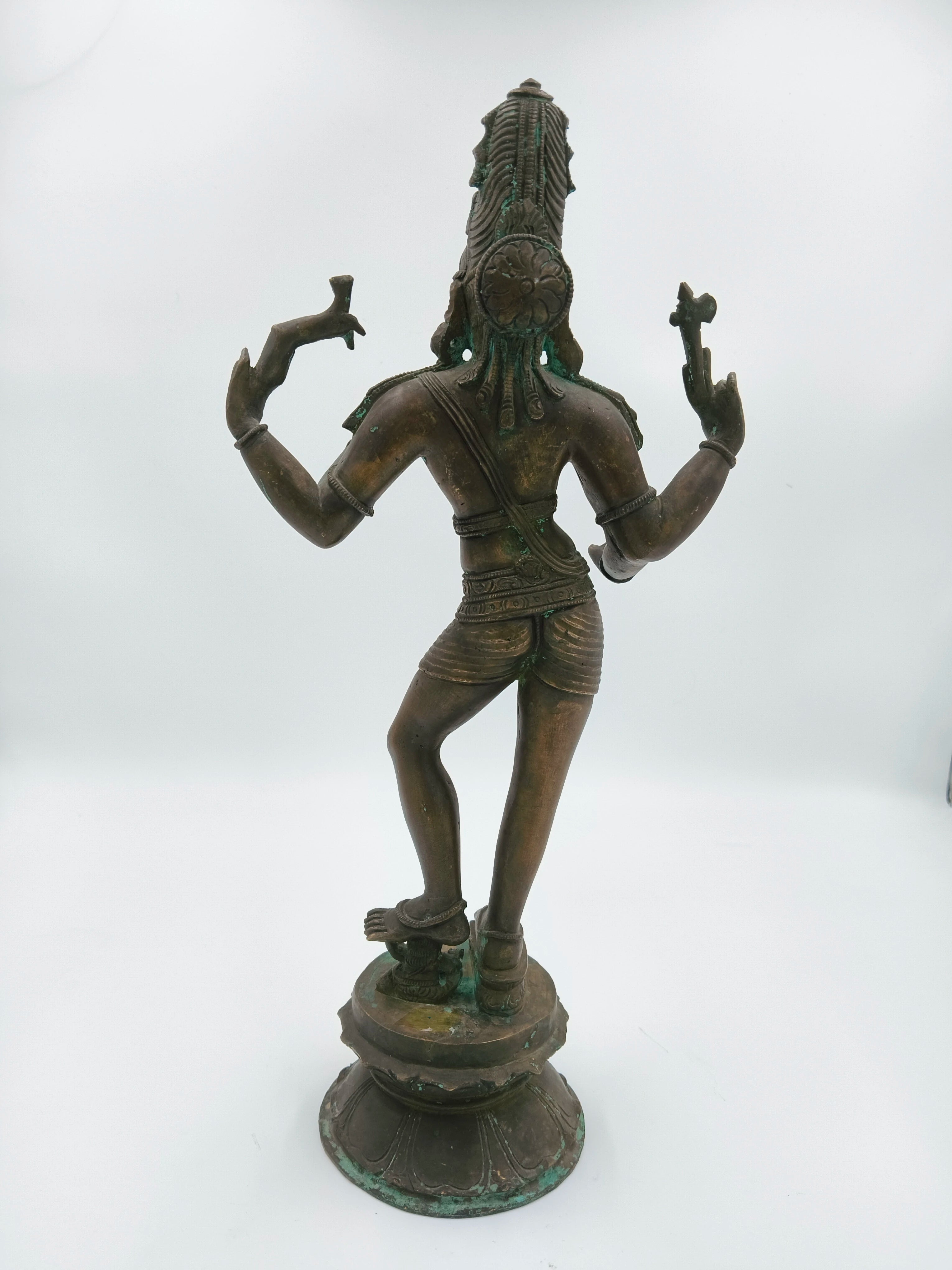 Back view of a large bronze standing Shiva sculpture on a decorative base