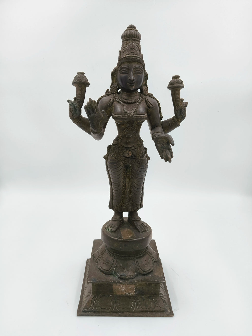 Bronze sculpture of Dhanvantari deity standing on a decorated square base