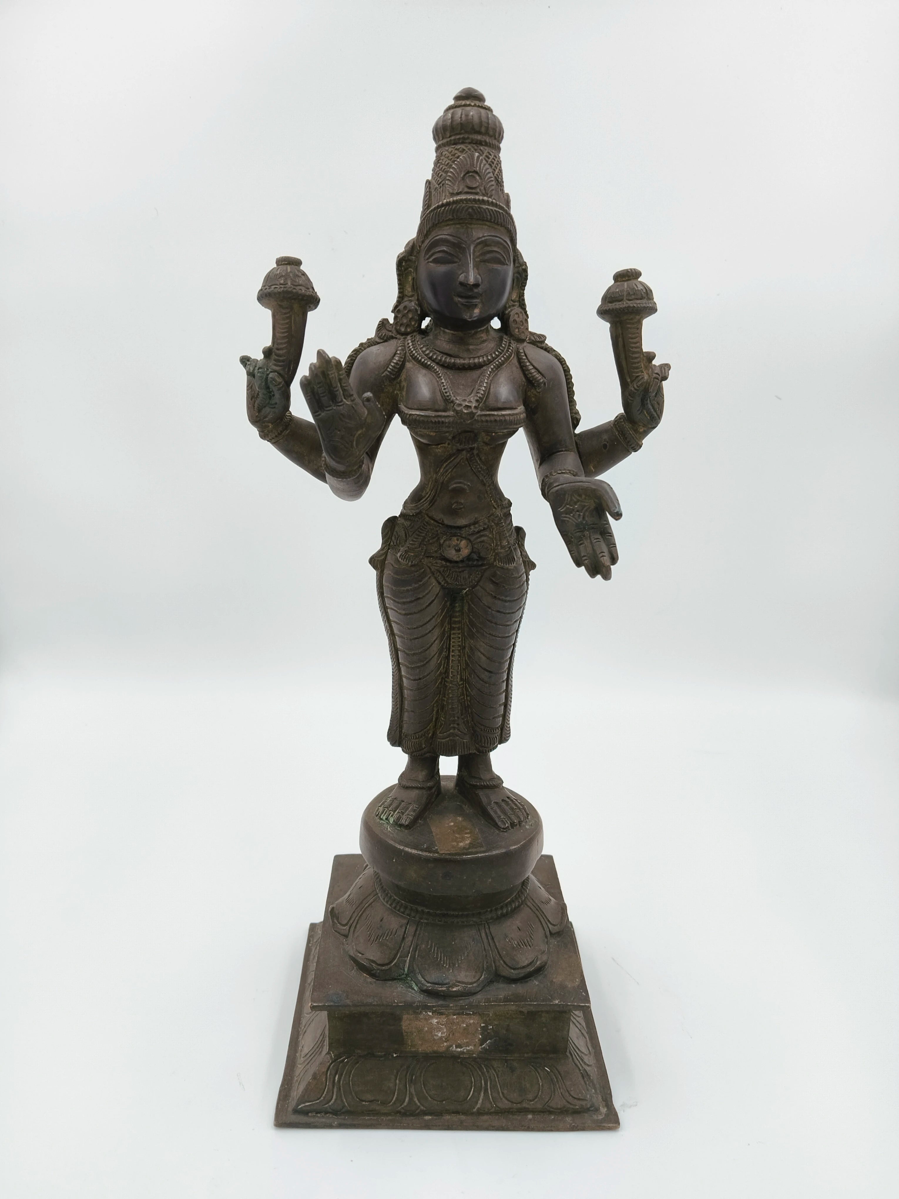Bronze sculpture of Dhanvantari deity standing on a decorated square base