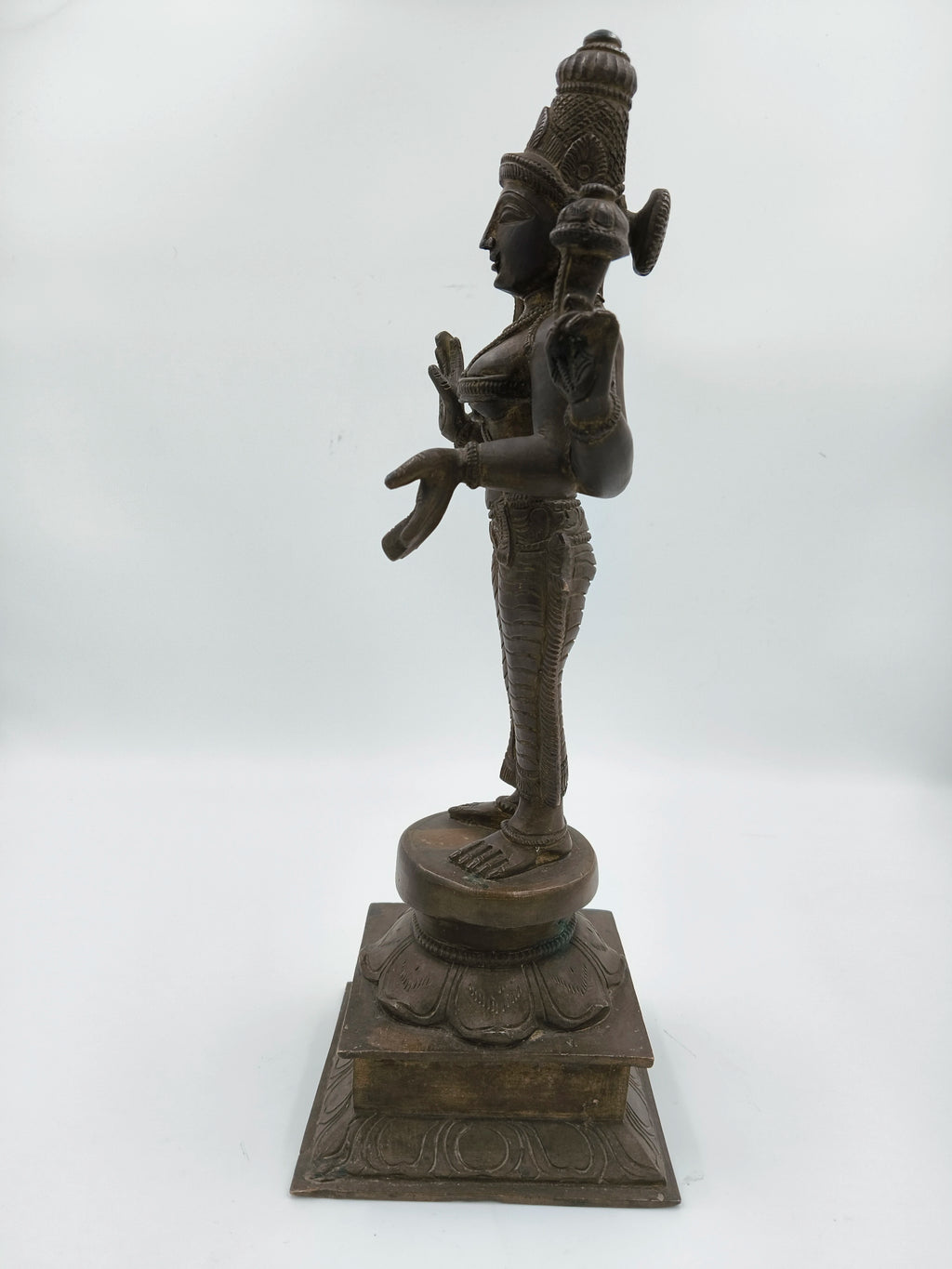 Side view of a bronze 12.5 inch Dhanvanthari statue on a square base
