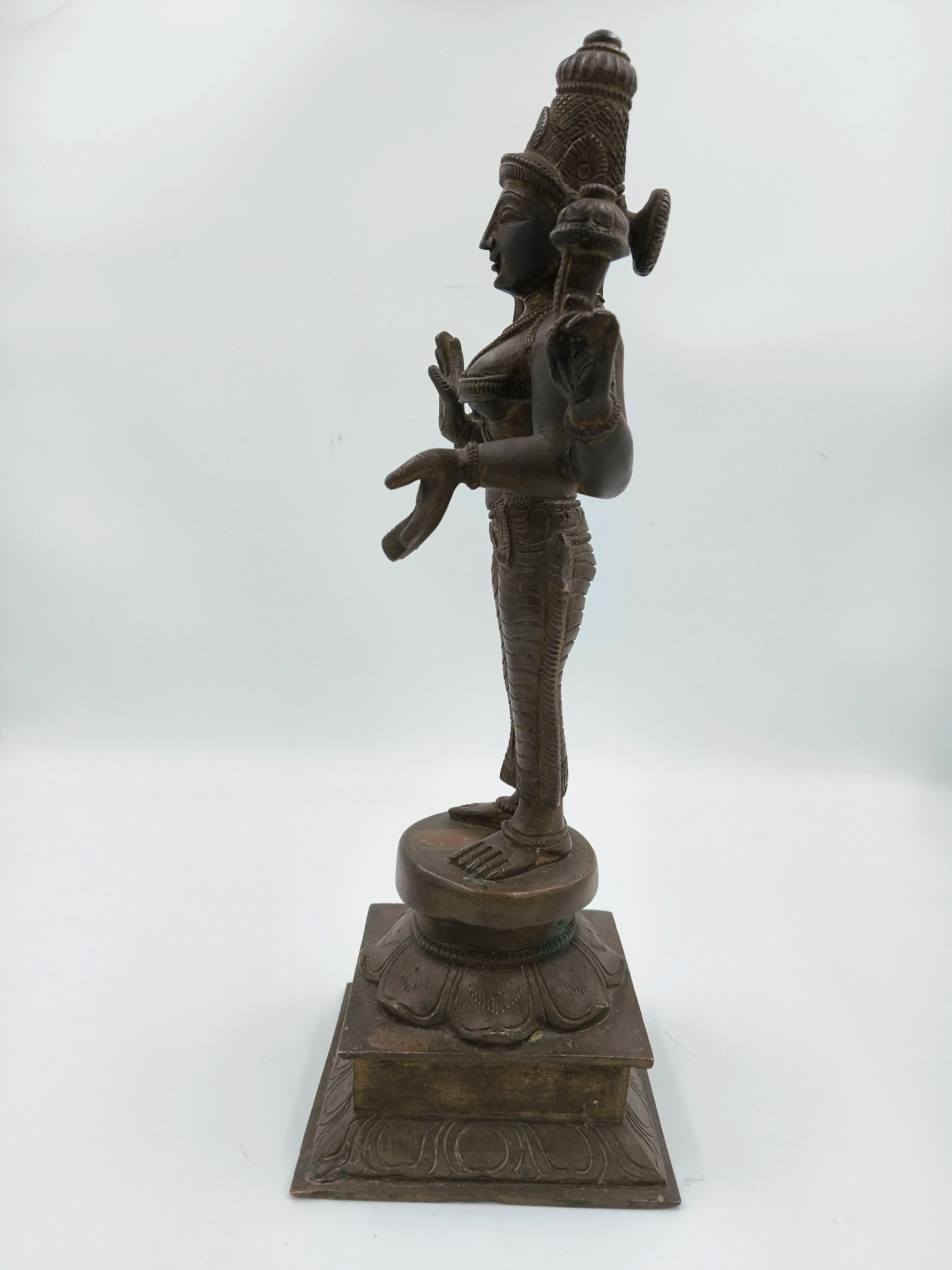 Side view of a bronze 12.5 inch Dhanvanthari statue on a square base