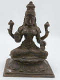 Large bronze sculpture of Lakshmi deity seated on lotus pedestal