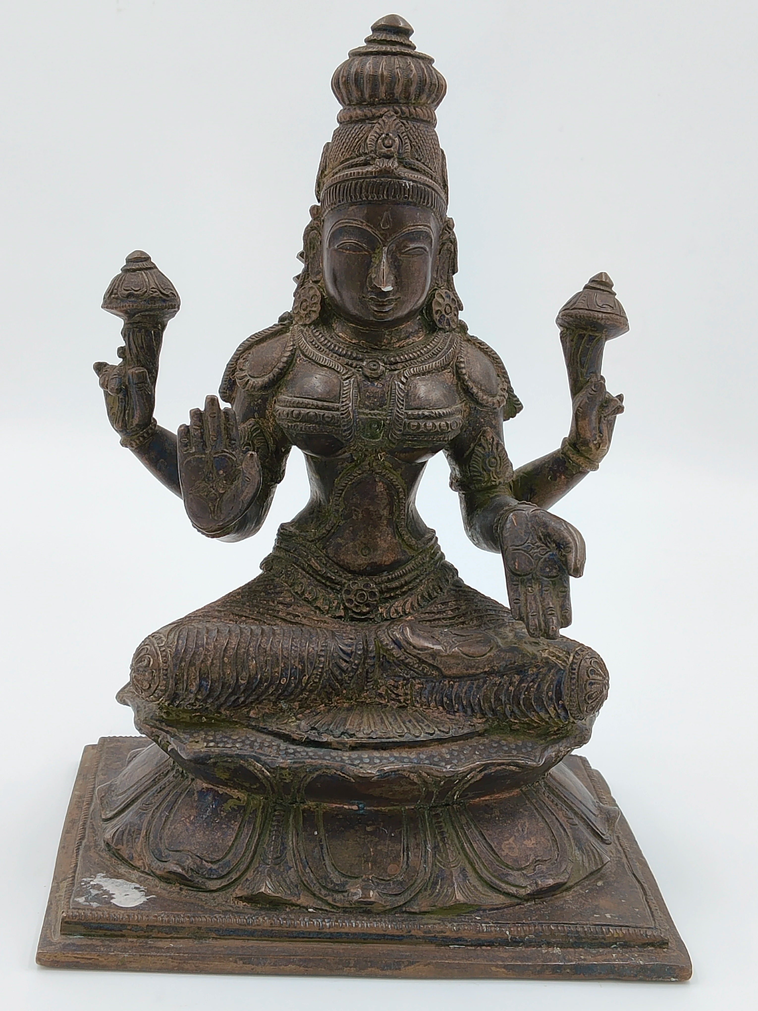 Large bronze sculpture of Lakshmi deity seated on lotus pedestal