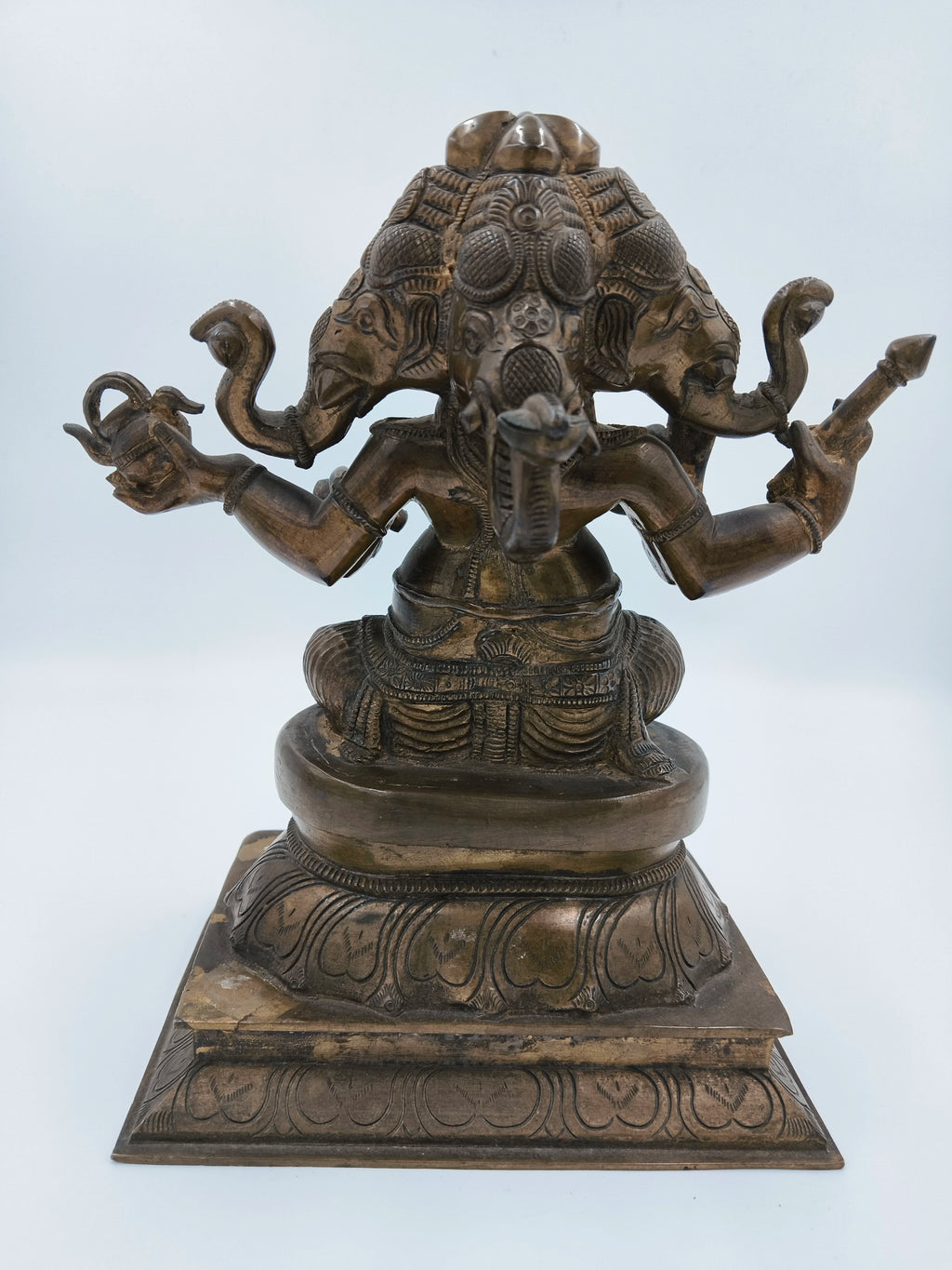 Back view of bronze 9-inch four-face Ganesh sculpture on decorative base