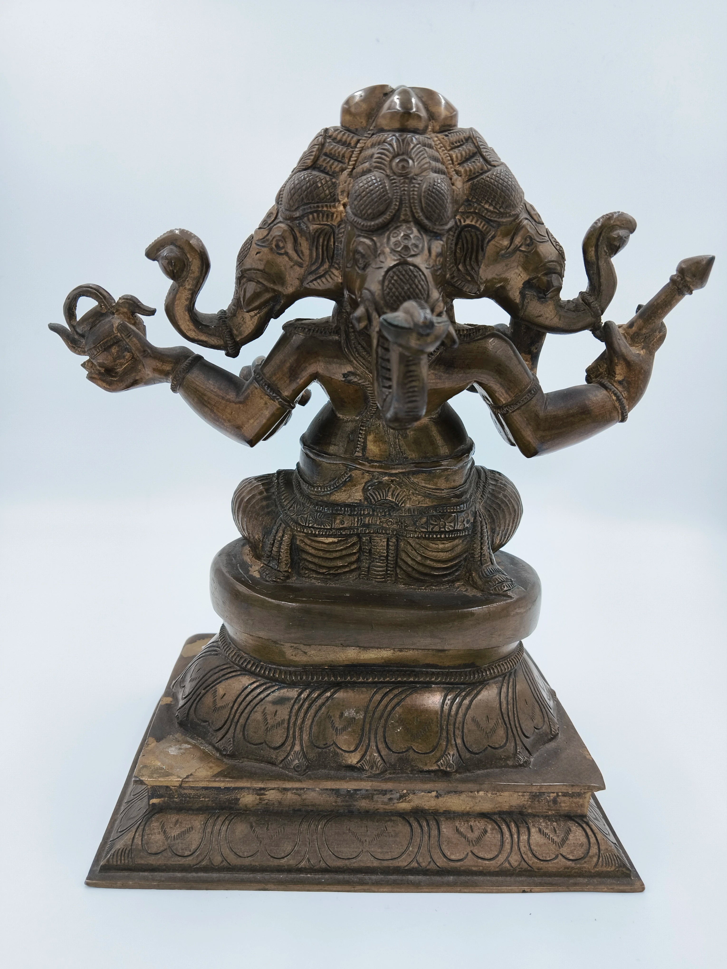 Back view of bronze 9-inch four-face Ganesh sculpture on decorative base