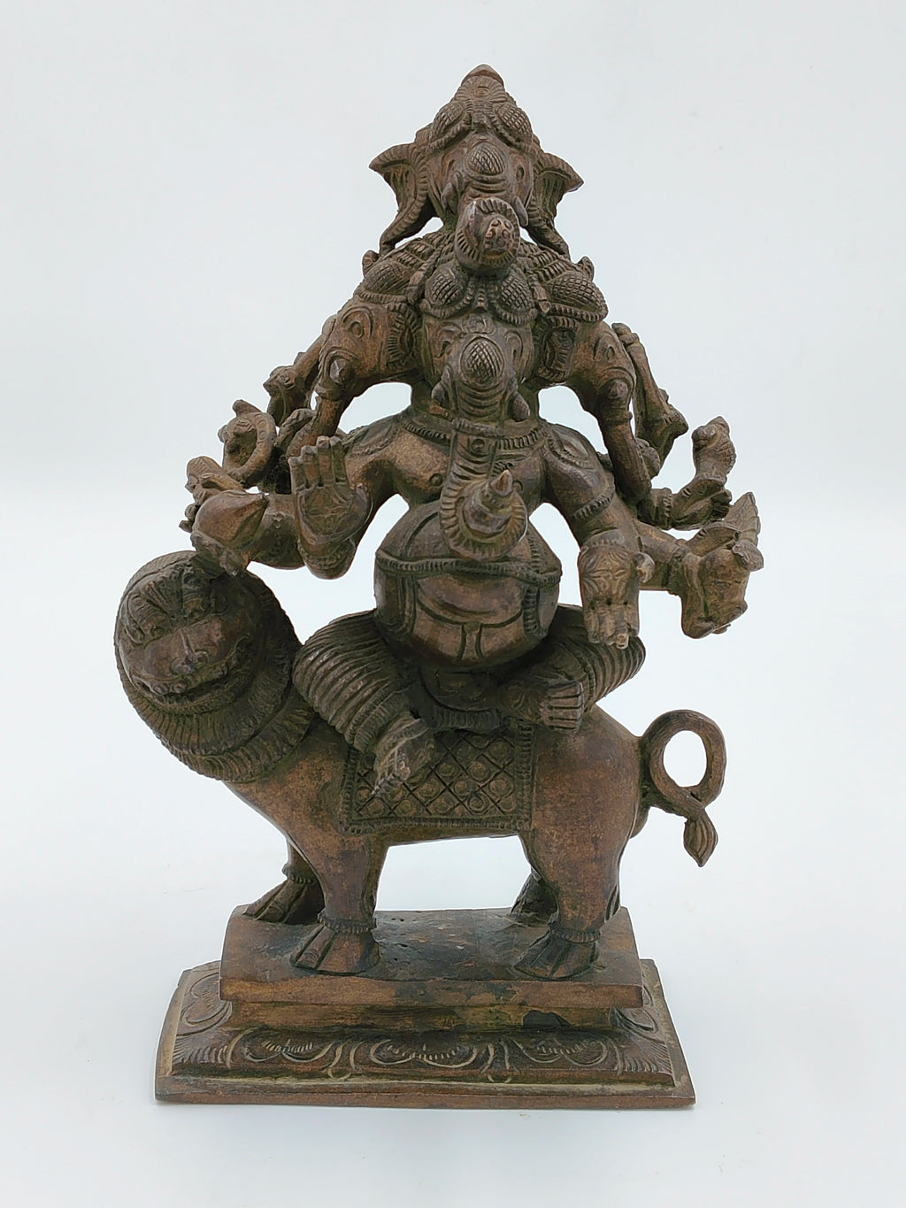 Bronze sculpture of five-faced Ganesh seated on a lion with detailed carvings